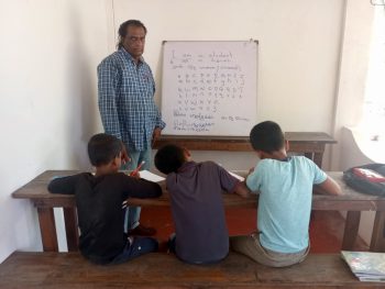 Elderly man teaches free english and sinahala classes to tamil students in sri lanka.