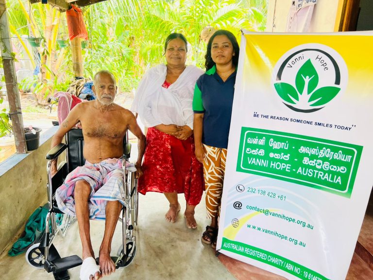 Vanni Hope initiative supporting disabled individuals in rural Sri Lanka, wheelchair donation improving mobility and dignity, sponsored by Mr. Sri Kulasegaram, elderly couple receiving essential health aid, uplifting families in Mutur Trincomalee, Vanni Hope volunteers delivering mobility support, restoring independence and hope, humanitarian project enhancing health and wellbeing, caring community action in Sri Lanka, empowering vulnerable families, compassionate aid fostering inclusion, promoting dignity and accessibility through kindness