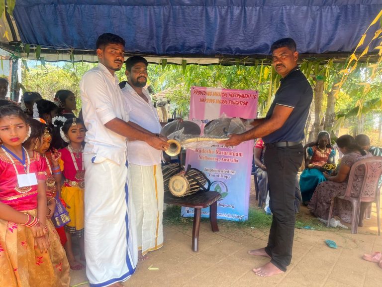 Students at Sri Gananatha Moral School in Vantharumoolai, Batticaloa, receiving new educational materials and musical instruments provided through the Vanni Hope Moral Education Support Project, sponsored by Radhesha Rasaratnam from Melbourne, Australia, promoting Hindu values, cultural pride, and moral learning in rural Sri Lanka