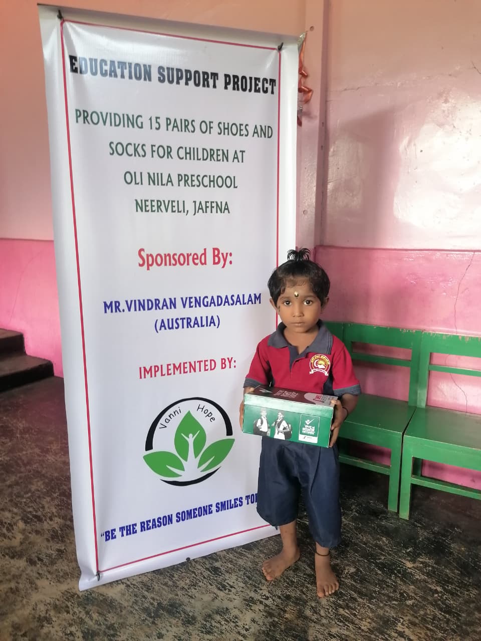 Preschool children in Neerveli, Jaffna, smiling and wearing new shoes and socks provided through a community education project supported by Mr. Vindran Vengadasalam from Australia, promoting comfort, confidence, and inclusion in early learning.