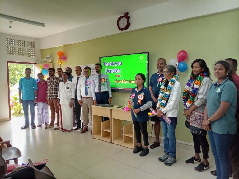 smart classroom installation, students using smart board, rural sri lankan school classroom, digital learning tools, teacher training session smart board, smart board interactive panel, classroom with Wi-Fi setup, education technology in kandy district, school name board installation, ups system for smart board, students engaging with digital lessons, modernized rural classroom environment