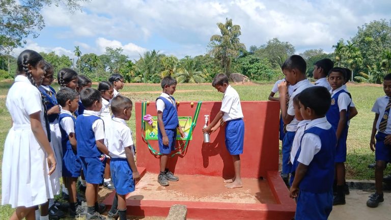 students accessing clean drinking water, rural school water facility Sri Lanka, Golindha Tamil Kanishta Vidyalayam, school tube well installation, children using school water source, Kegalle district rural school, safe drinking water for students, school hygiene and wellbeing, plantation community school Sri Lanka, clean water access in schools