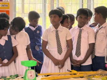Konavil Kanthy Primary School signboard Kilinochchi Sri Lanka, students and teachers gathered during mathematics classroom opening event, children standing together during school program in Kilinochchi, students participating in school education project event Sri Lanka, school community gathered for mathematics classroom opening ceremony, primary school students in uniform attending education initiative, students interacting during mathematics classroom project event, rural Sri Lanka school education support program