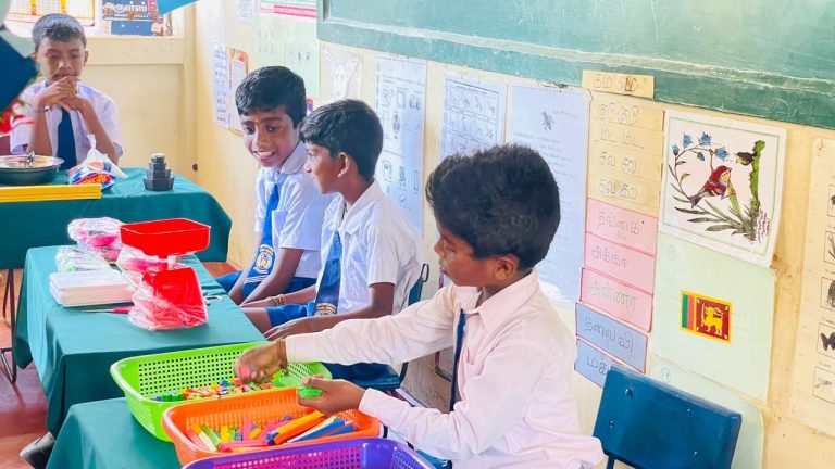 Pookkaddy GTM School mathematics classroom opening Jaffna, students using mathematics learning tools in classroom Sri Lanka, school children engaged in lessons with new resources, teachers and students at classroom event Jaffna, mathematics equipment displayed in classroom Sri Lanka, rural school education support Northern Province, students participating in interactive learning activities, classroom environment with students and teachers Sri Lanka