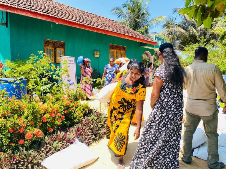 women receiving plant seedlings in Muttur, home gardening support distribution Sri Lanka, grow bags and compost distribution for women farmers, climate resilient agriculture initiative Trincomalee, women beneficiaries Puthumai Pengal Society