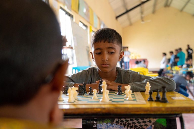 youth chess tournament Sri Lanka, chess competition Hatton, students playing chess in school auditorium, young players competing in organized tournament, winners receiving trophies and prizes, certificates awarded to participants, group of students and organizers at chess event, intellectual sports activity for youth