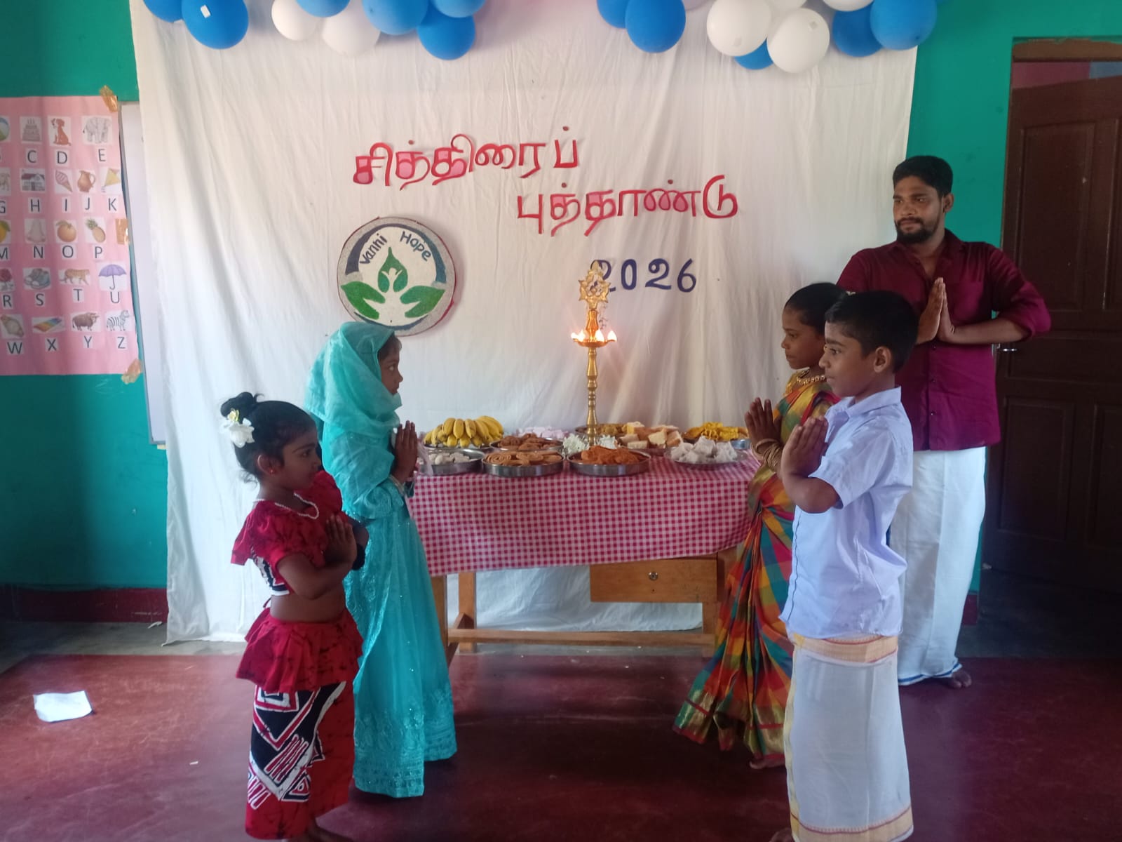 students celebrating Tamil New Year at Sri Gananatha Araneri School, traditional Tamil cultural performances in Batticaloa, students in festive attire during Puthandu celebration, Tamil New Year school event in Sri Lanka, Vanni Hope community cultural programme, Vantharumoolai cultural celebration, children participating in traditional games and activities